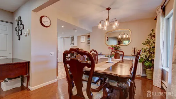 a view of a dining room with furniture and chandelier