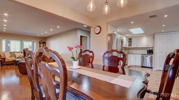 a living room with lots of furniture and kitchen view