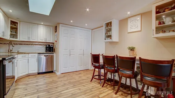 a view of kitchen with cabinets and wooden floor