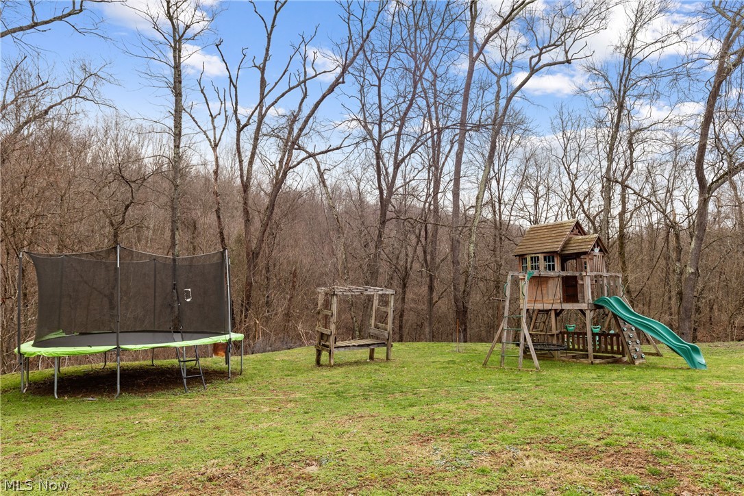 38340 Lees Run Road Cadiz, OH 43907 - Photo 28 of 31 View of grassy yard featuring a trampoline and a playground