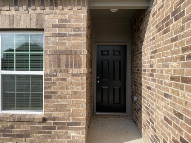 18741 Speculator Lane Elgin, TX 78621 - Photo 5 of 28 Property entrance with brick siding