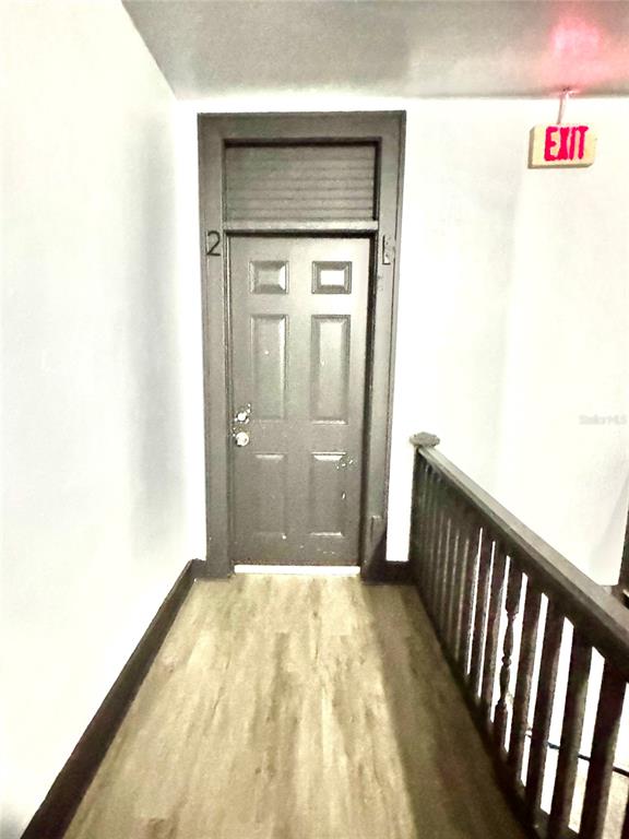 35 North 6th Street, Unit 2 Haines City, FL 33844 - Photo 4 of 9 a view of a hallway with wooden floor and a bathroom