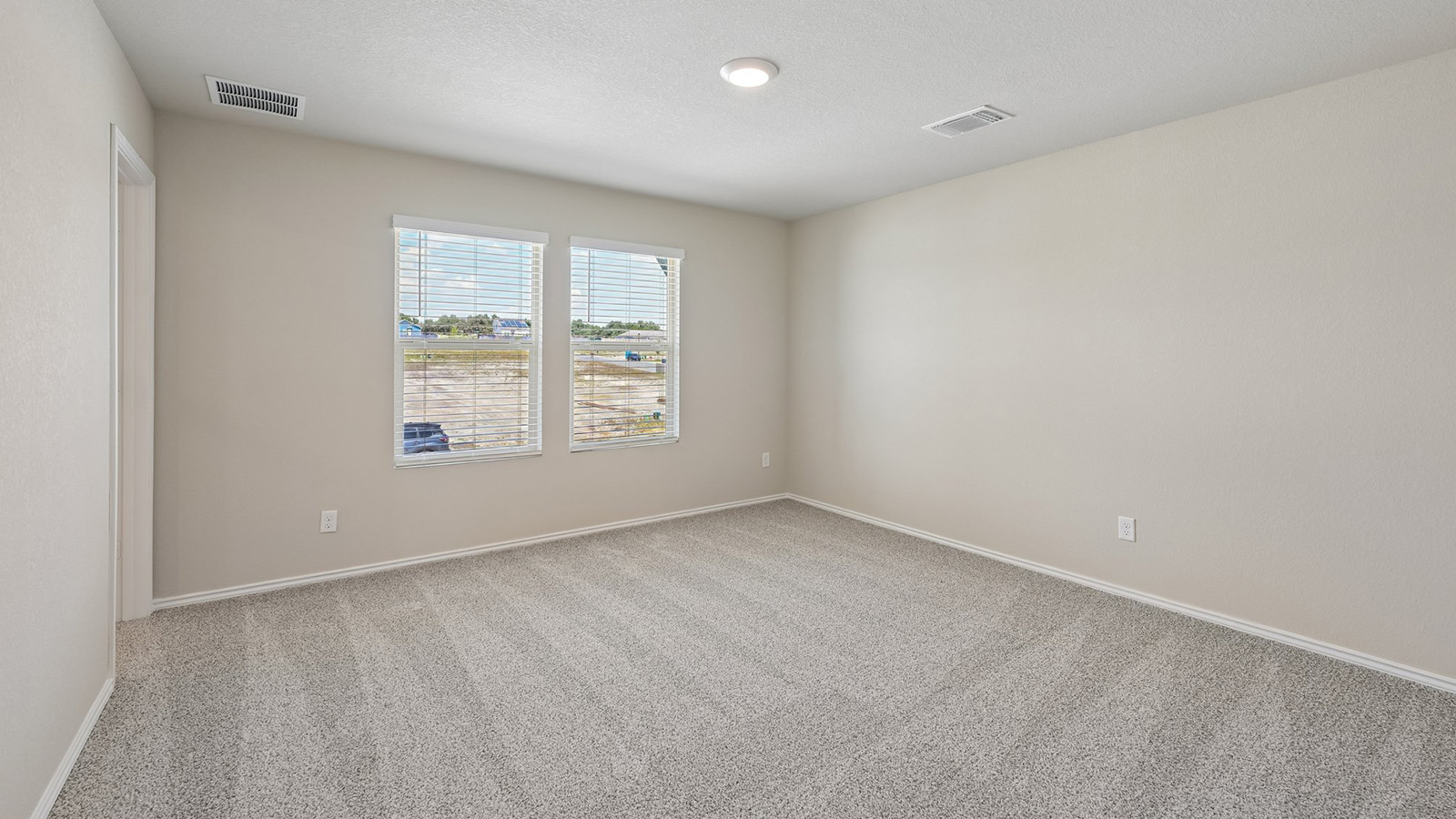 372 Old Stage Coach Road Jarrell, TX 76537 - Photo 10 of 25 Plush carpeting and dual windows create a comfortable and inviting atmosphere.