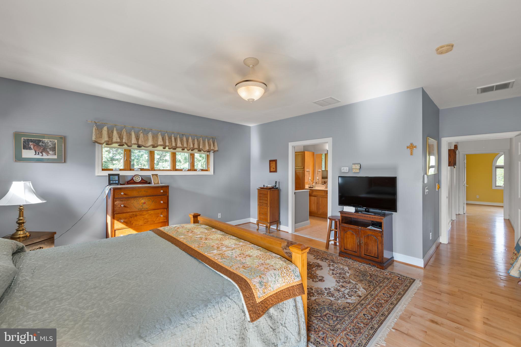237 Aspen Trail Winchester, VA 22602 - Photo 28 of 69 a bedroom with a bed and wooden floor