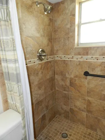 a bathroom with a shower and a sink