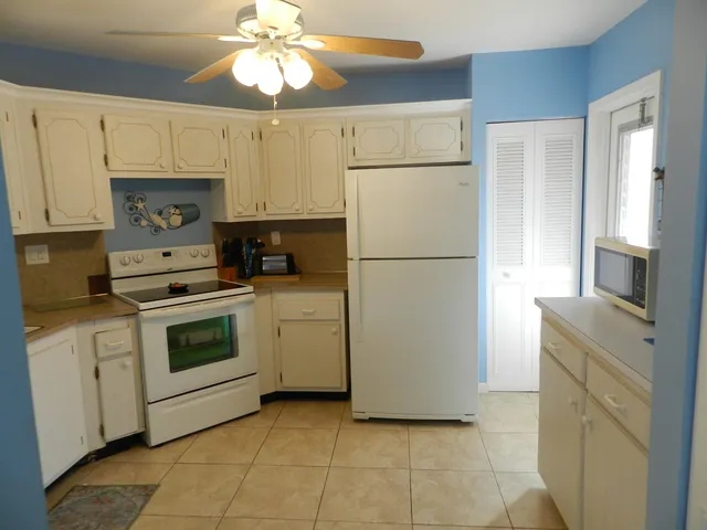 a kitchen with cabinets stainless steel appliances and a counter space
