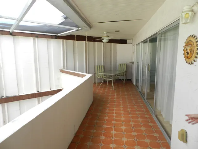 a view of balcony with wooden floor and furniture