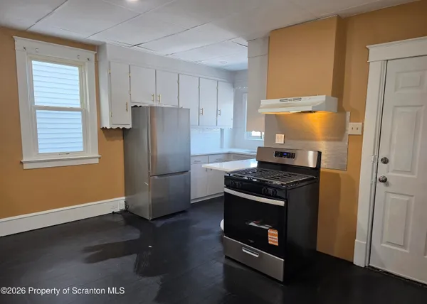 a kitchen with a stove and a refrigerator