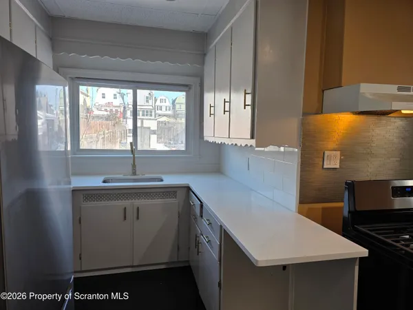 a kitchen with a sink stove and cabinets