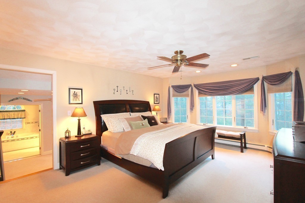 106 Flint Farm Road Middleton, MA 01949 - Photo 19 of 30 a bedroom with a bed and a chandelier