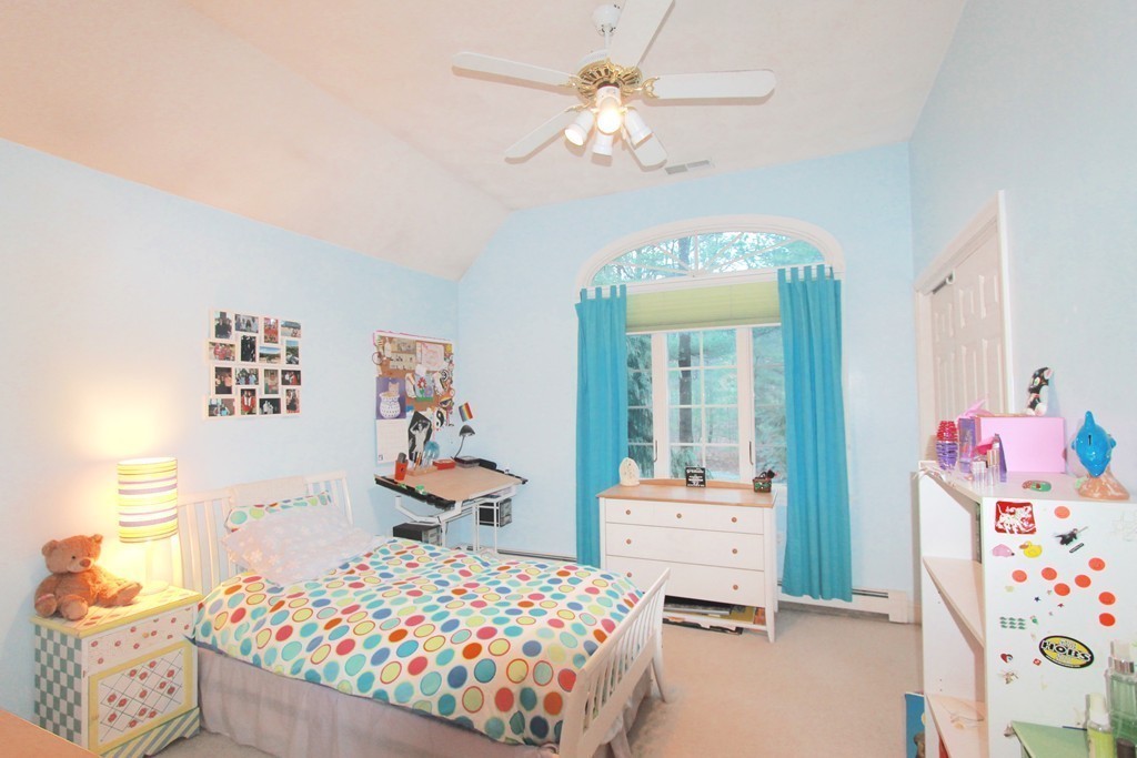 106 Flint Farm Road Middleton, MA 01949 - Photo 24 of 30 a bedroom with a bed and a chandelier