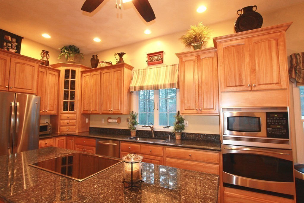 106 Flint Farm Road Middleton, MA 01949 - Photo 9 of 30 a kitchen with stainless steel appliances a sink and a refrigerator