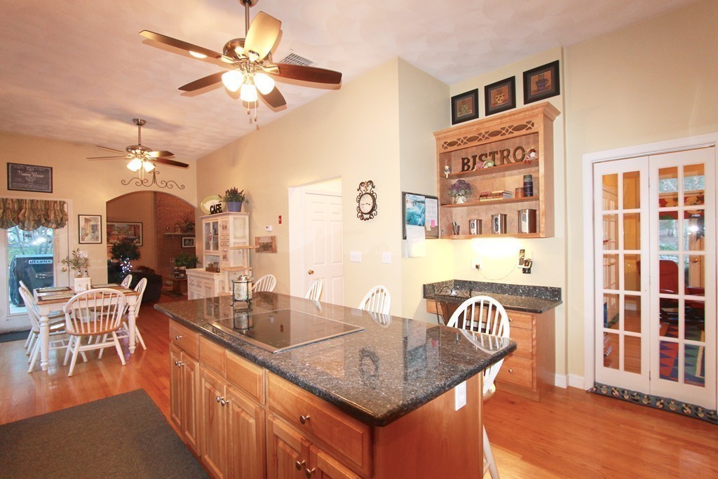 106 Flint Farm Road Middleton, MA 01949 - Photo 10 of 30 a dining table with chairs and a chandelier