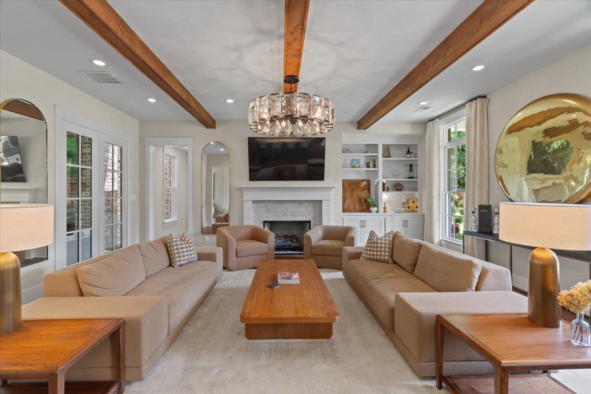 240 Burrows Road Collierville, TN 38017 - Photo 2 of 37 Living area featuring exposed wood beams and a central chandelier