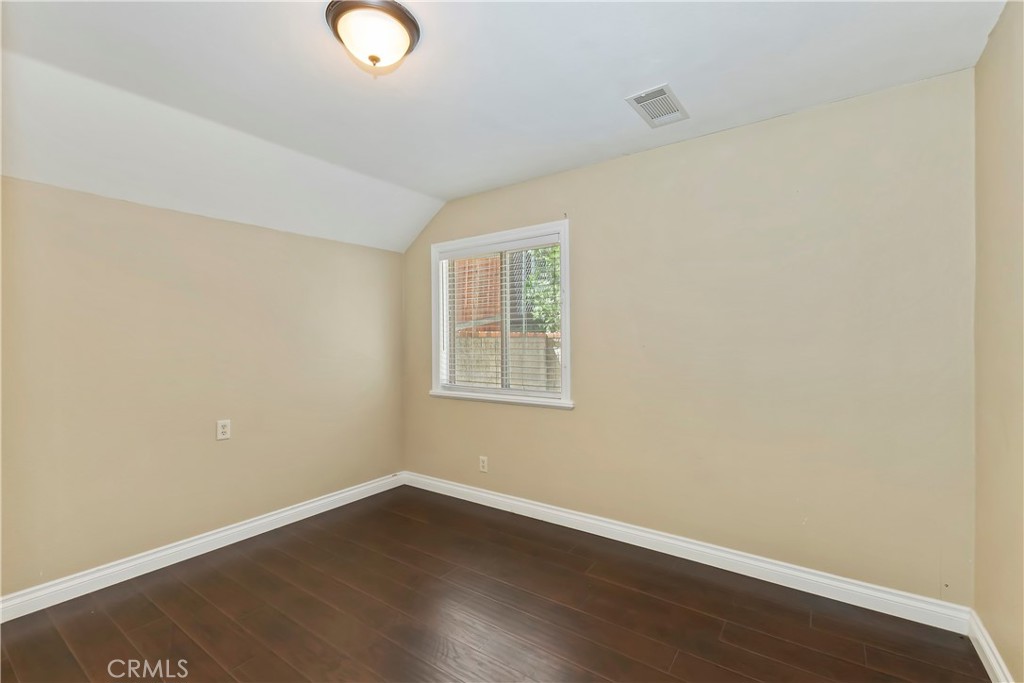 23739 Hillside Drive Crestline, CA 92325 - Photo 14 of 37 an empty room with wooden floor and windows