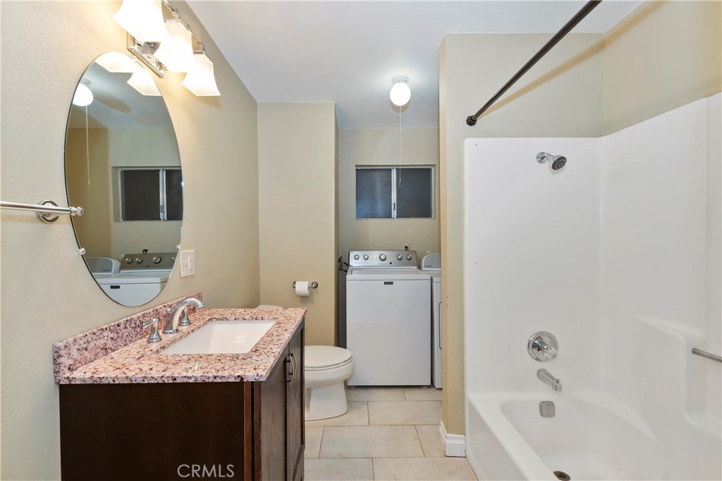 23739 Hillside Drive Crestline, CA 92325 - Photo 16 of 37 a bathroom with a granite countertop sink and a mirror