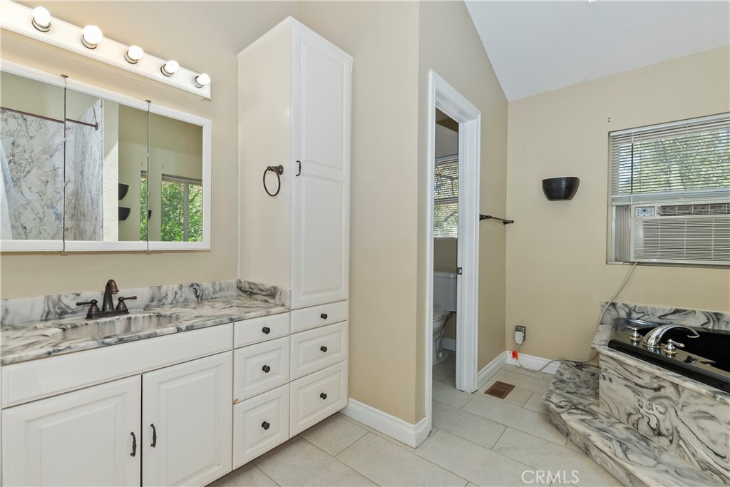 23739 Hillside Drive Crestline, CA 92325 - Photo 20 of 37 a spacious bathroom with a double vanity sink a mirror and a shower