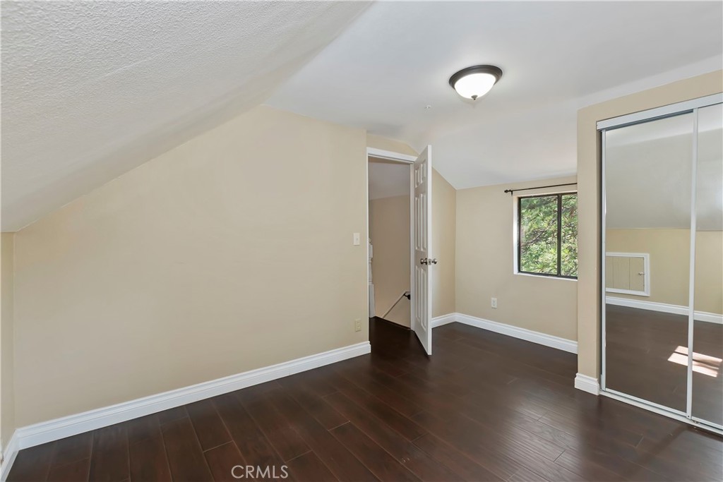 23739 Hillside Drive Crestline, CA 92325 - Photo 22 of 37 an empty room with wooden floor and windows