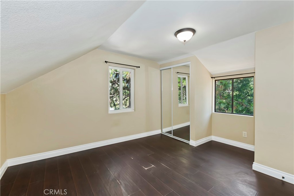 23739 Hillside Drive Crestline, CA 92325 - Photo 24 of 37 an empty room with wooden floor and windows