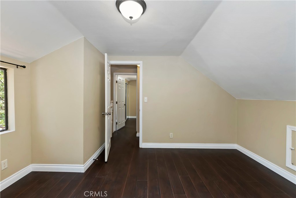 23739 Hillside Drive Crestline, CA 92325 - Photo 27 of 37 an empty room with wooden floor and windows