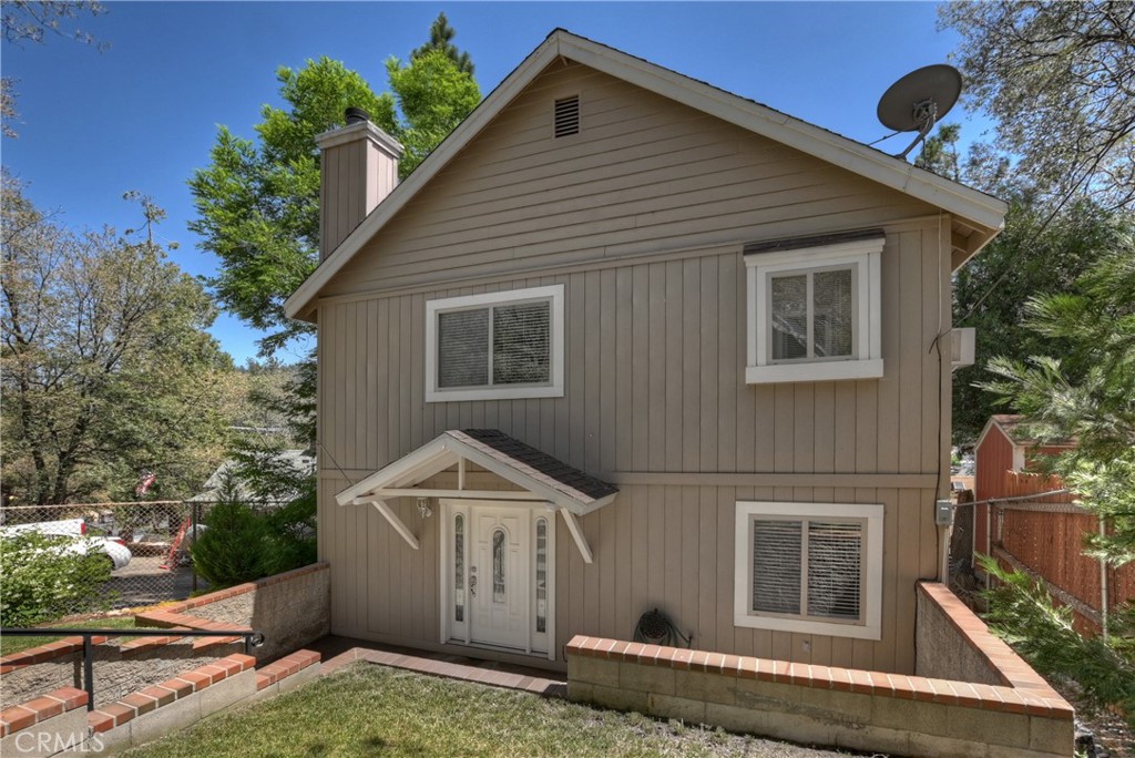 23739 Hillside Drive Crestline, CA 92325 - Photo 3 of 37 a front view of a house with a yard