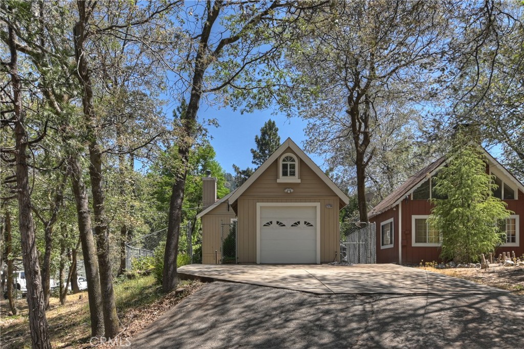 23739 Hillside Drive Crestline, CA 92325 - Photo 32 of 37 a front view of a house with a yard and trees