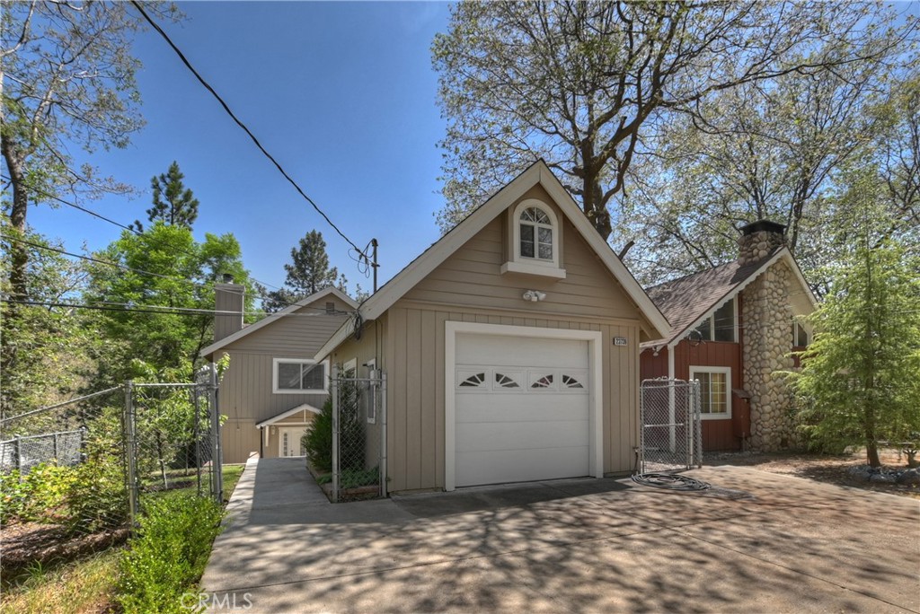 23739 Hillside Drive Crestline, CA 92325 - Photo 33 of 37 a front view of a house with a yard and garage