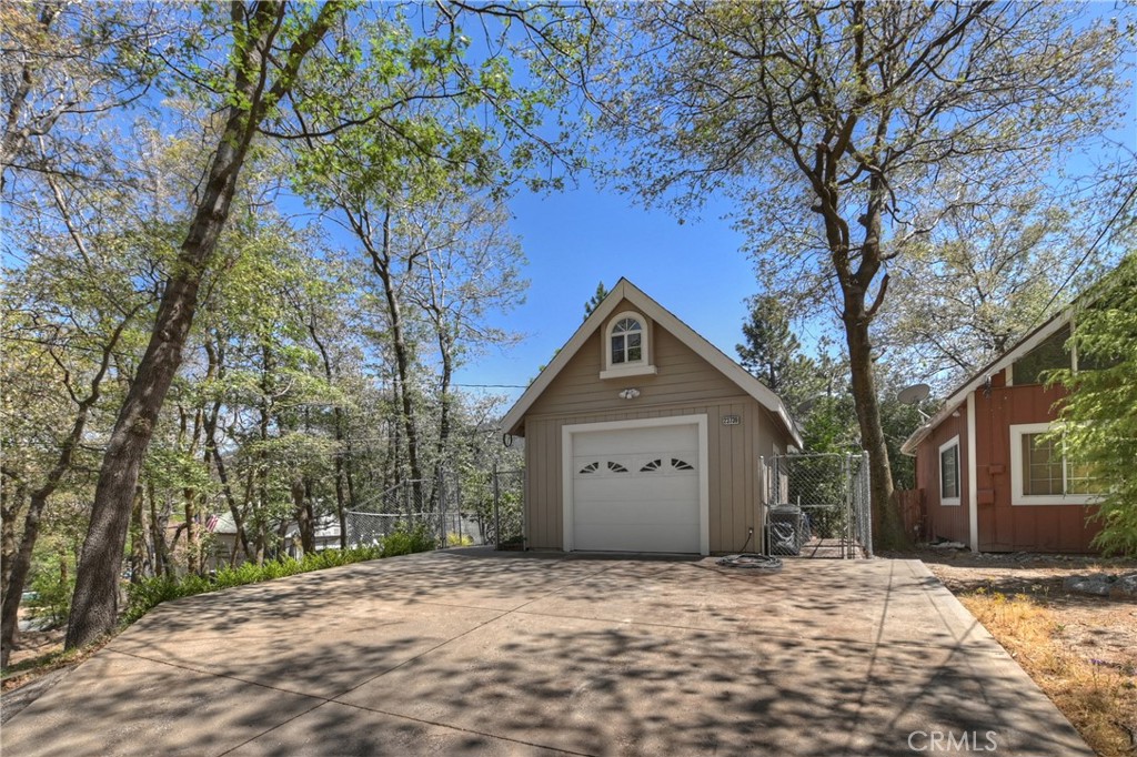 23739 Hillside Drive Crestline, CA 92325 - Photo 34 of 37 a front view of a house with a yard and garage