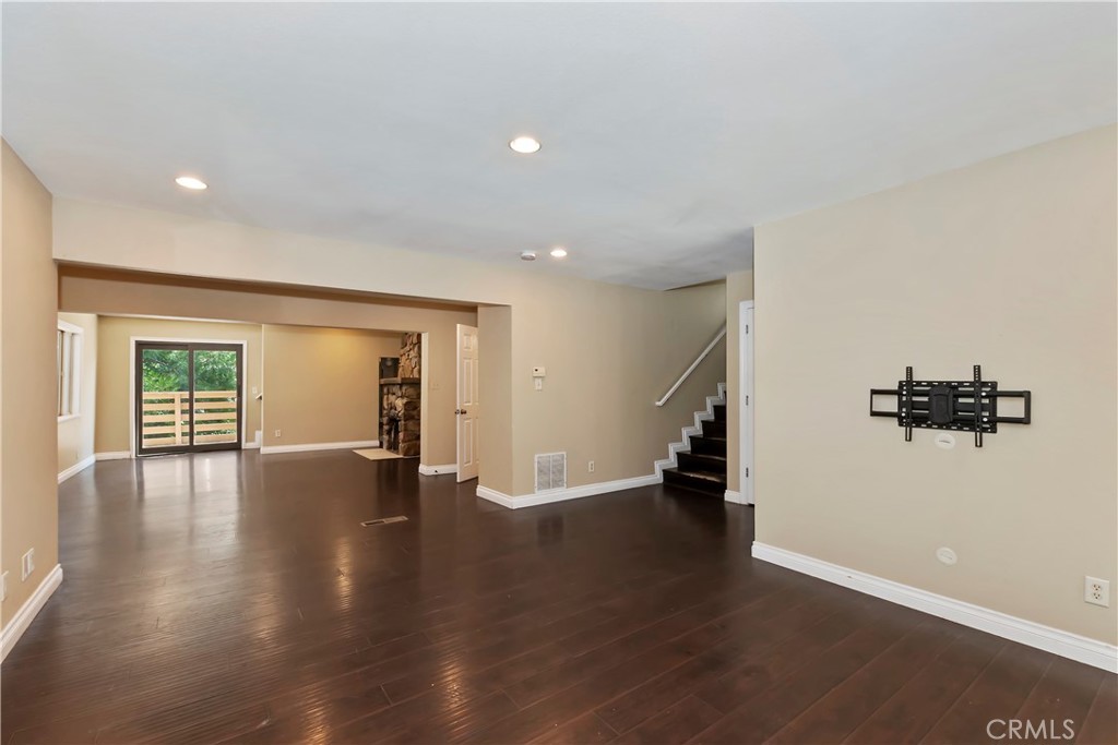 23739 Hillside Drive Crestline, CA 92325 - Photo 7 of 37 a view of an empty room with wooden floor and a window