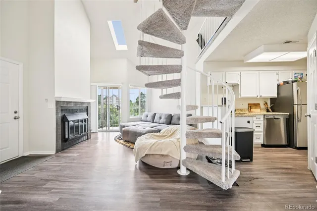a living room with furniture fireplace and wooden floor