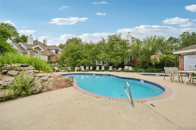 a view of swimming pool with outdoor seating and plants