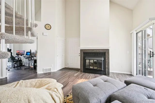 a living room with furniture and a fireplace