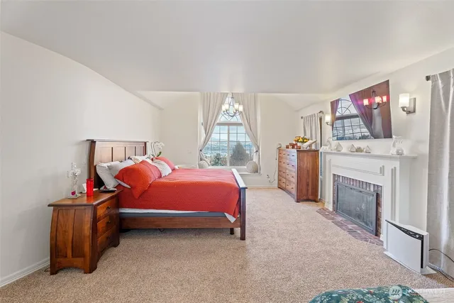 a bedroom with a bed and a fireplace