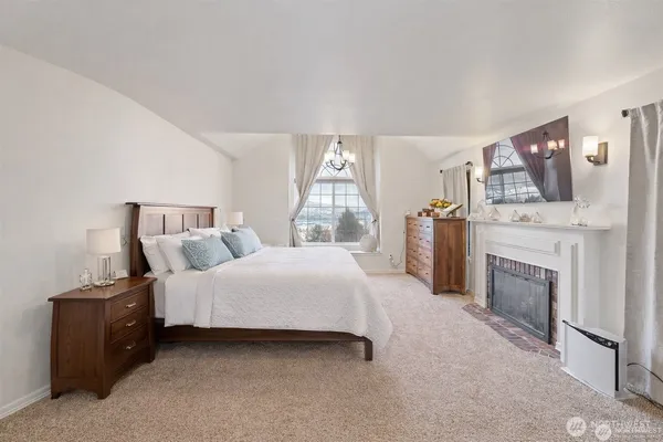 a bedroom with a bed and a fireplace