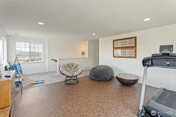 a living room with furniture a flat screen tv and a window