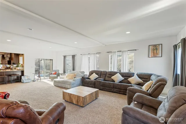 a kitchen with stainless steel appliances granite countertop a stove a sink dishwasher and a refrigerator with wooden floor