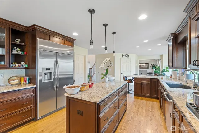 a kitchen with refrigerator and cabinets