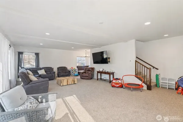 a living room with furniture a couch and white walls