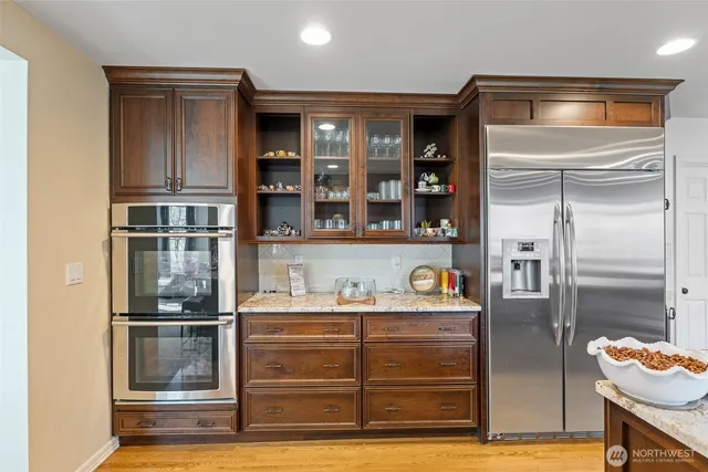 a kitchen with stainless steel appliances granite countertop counter space a sink and a refrigerator