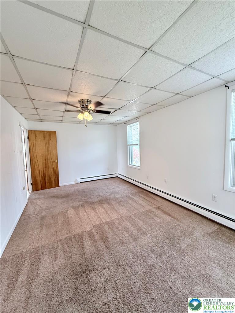 5540 Main Street Whitehall, PA 18052 - Photo 34 of 53 Primary bedroom carpeting and a bright ceiling fan enhance this cozy interior space.