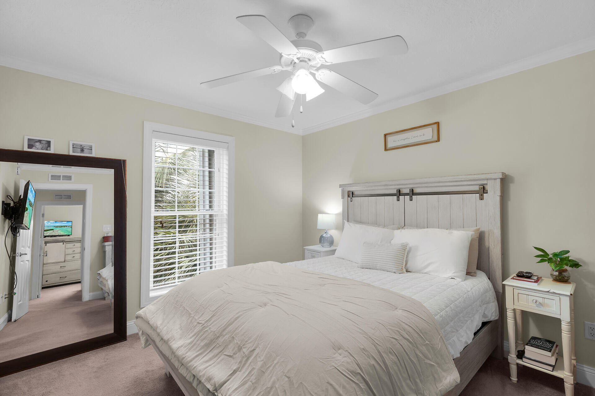 320 24th Street Ocean Marathon, FL 33050 - Photo 29 of 46 a bedroom with a large bed and a chandelier