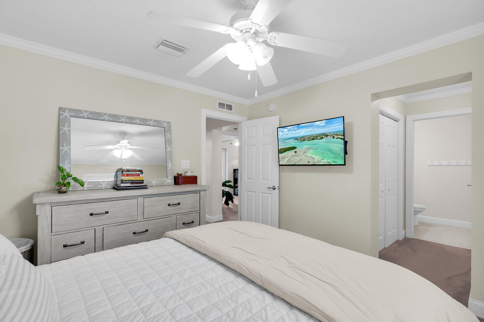 320 24th Street Ocean Marathon, FL 33050 - Photo 30 of 46 a bedroom with a bed and a chandelier