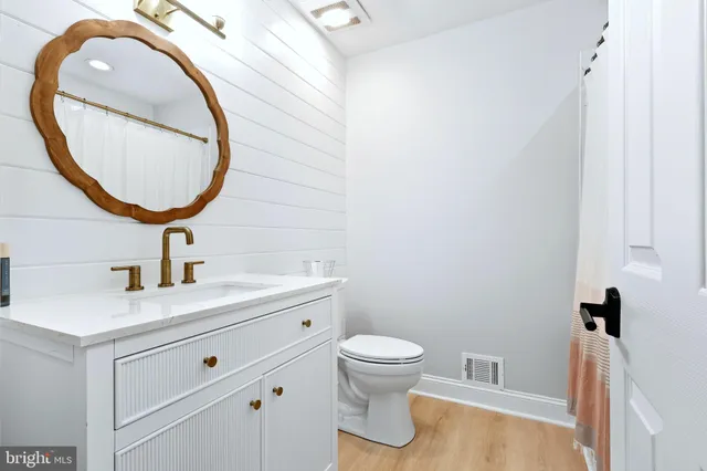 a bathroom with a sink a toilet and a mirror