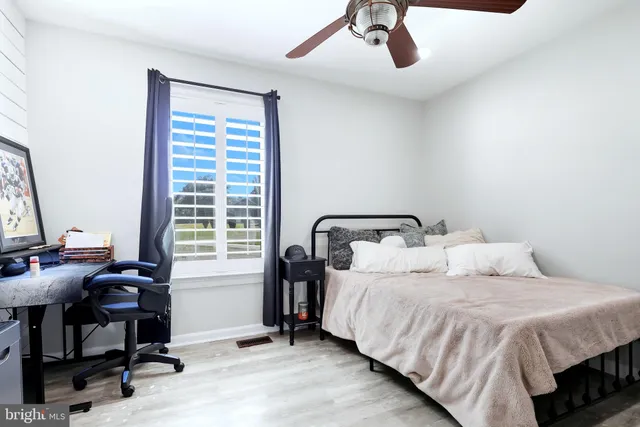 a bedroom with a bed and a desk