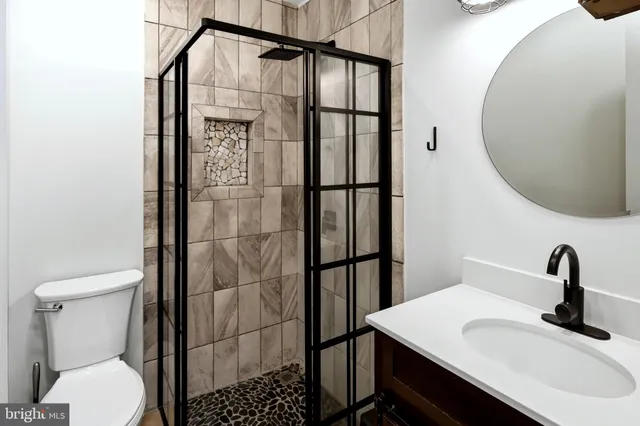 a bathroom with a sink toilet and shower