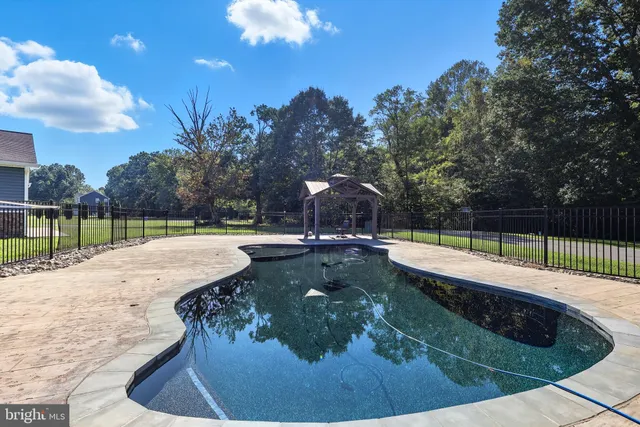a view of a swimming pool with a sitting in the background