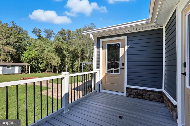 a view of a deck with wooden floor and fence
