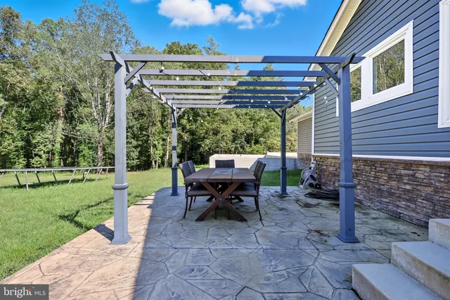 a view of a patio with a table chairs and a backyard