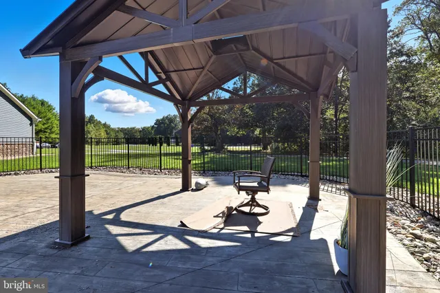 a view of a porch with chairs and backyard