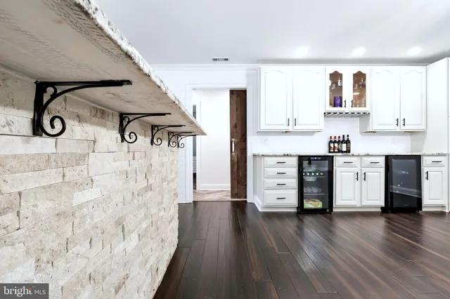a view of kitchen with cabinets and wooden floor